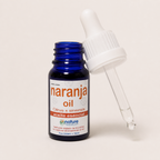 Naranja Oil (aceite esencial) — el envase abierto, con el gotero apoyado